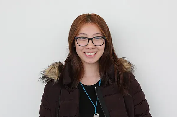 female student smiling with a white background